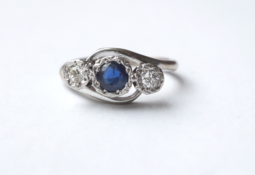 ATTRACTIVE SAPPHIRE AND DIAMOND THREE STONE TWIST DESIGN RING
the central sapphire approximately 0.