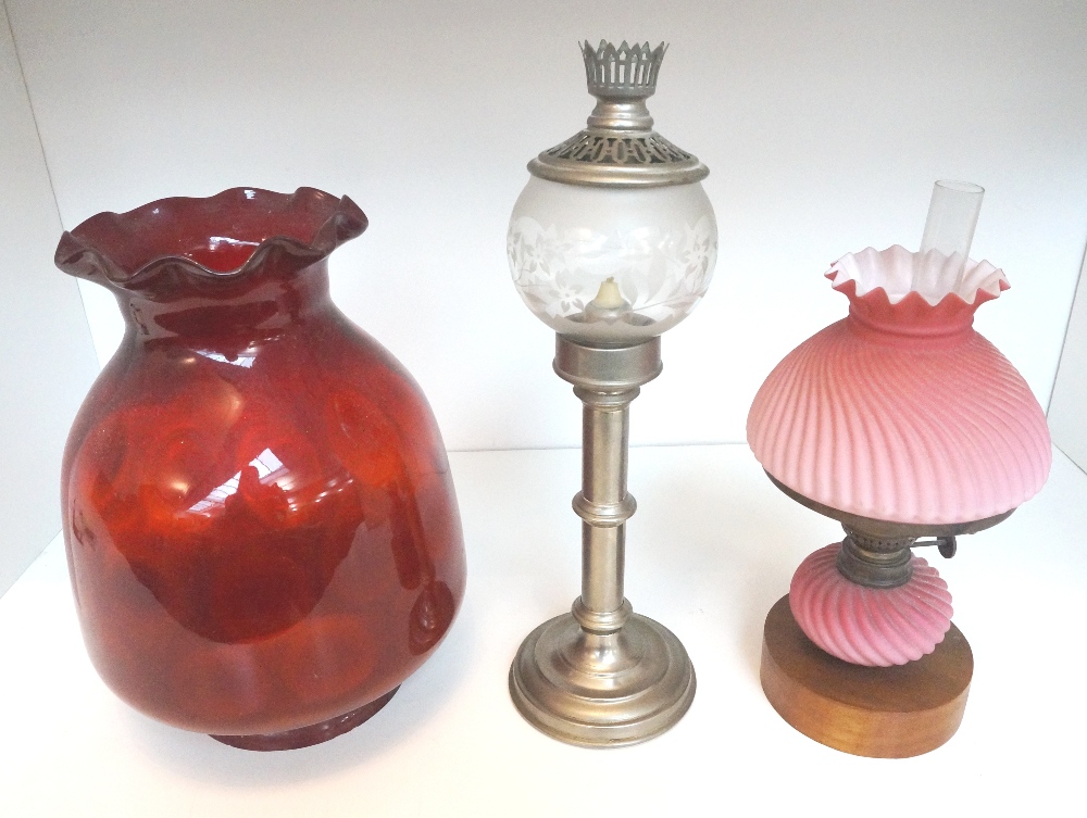 EARLY 20th CENTURY OIL LAMP
with a wavy rimmed coral coloured glass shade and reservoir, a large