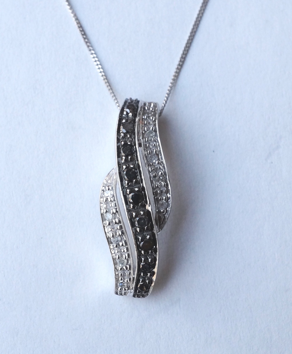 BLACK AND WHITE DIAMOND PENDANT 
in nine carat white gold and on nine carat white gold chain