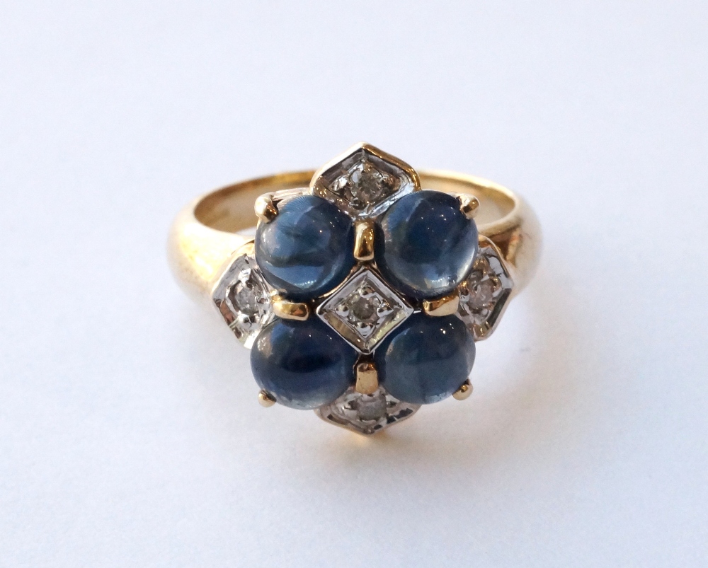 SAPPHIRE AND DIAMOND CLUSTER DRESS RING
set with cabochon sapphires and round cut diamonds, on