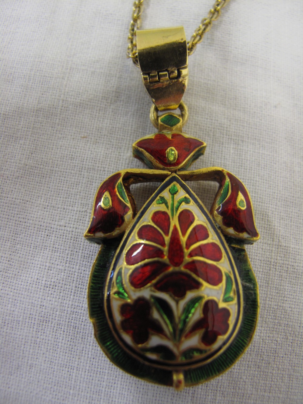 Indian Mogul style jewelled and enamel teardrop shaped pendant with emerald style main stone and