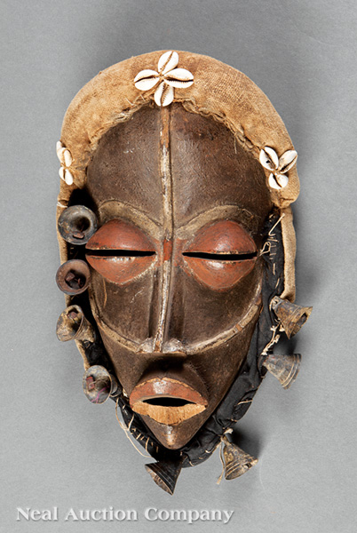 An African Polychrome Painted Carved Wood Mask, hollowed almond form carved with exaggerated