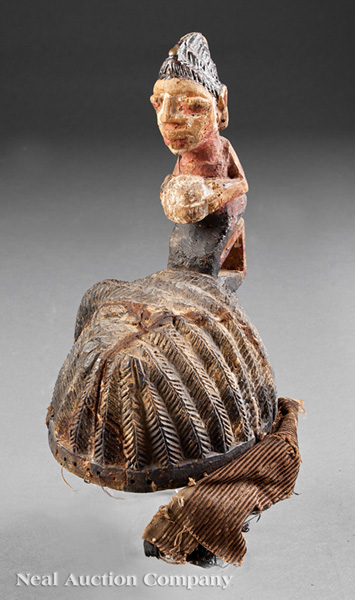 A Yoruba Polychrome Painted Carved Wood Headdress, Nigeria, hollowed domed form carved with