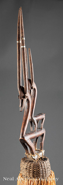 A Bamana Carved Wood Chiwara Headdress, Mali, carved as a stylized standing female antelope