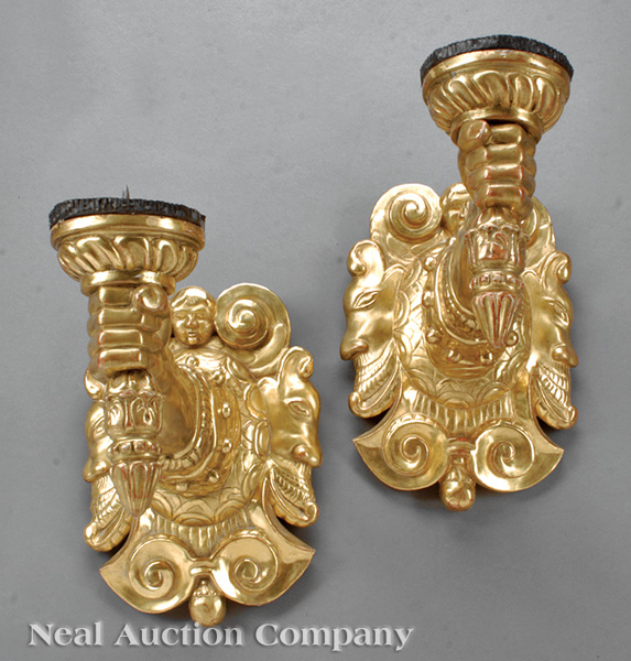 A Pair of Renaissance-Style Carved Giltwood Prickets, scroll and mask shield issuing arm-form