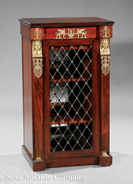 An Empire-Style Gilt Bronze-Mounted Mahogany Side Cabinet, molded top, paneled frieze, grillework