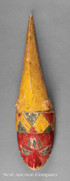 A Yoruba Polychrome Painted Carved Wood Gelede Mask, Nigeria, hollowed oval visage with conical