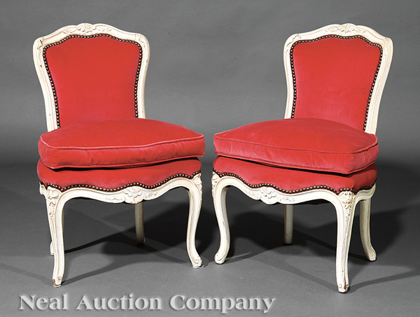 A Pair of Louis XV-Style Carved and Crème Peinte Upholstered Chaises, shaped floral crest rail,