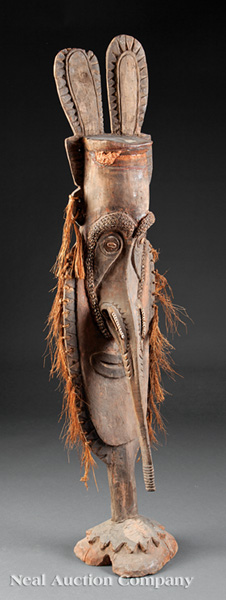 A Sepik Polychrome Painted Carved Wood Guardian Figure, New Guinea, elongated oval visage carved