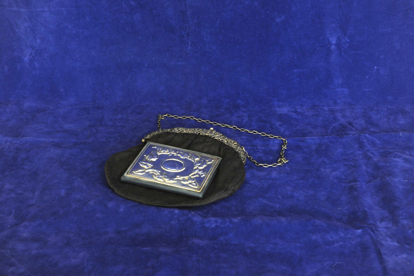 A ladies evening bag, the white metal clasp with pierced cast decoration of children dancing amongst