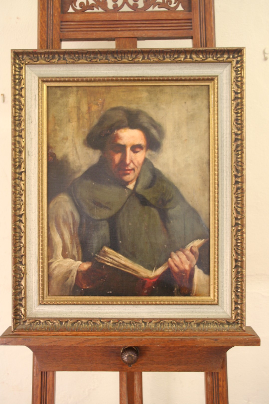 A 19th century oil on canvas of a monk reading a book. Unsigned. 13½ by 17½ins. In a gilt frame.