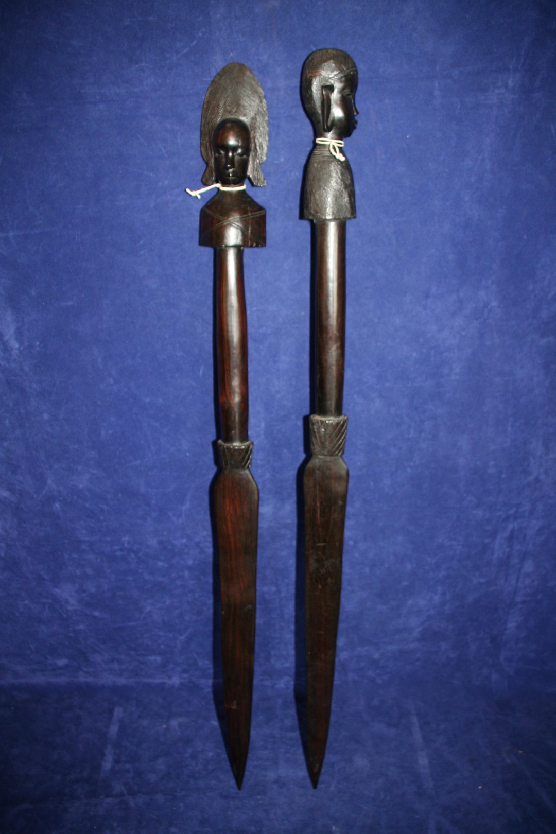 Two South Sea Island carved hardwood ornamental spears with figure head decorations to the handles