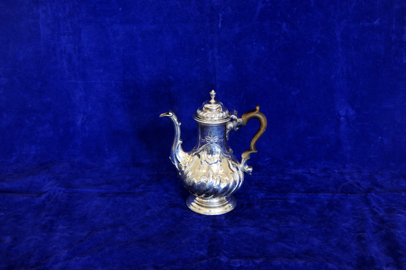 A George II silver coffee pot with gadrooned lid, turned fruitwood handle and acanthus leaf cast