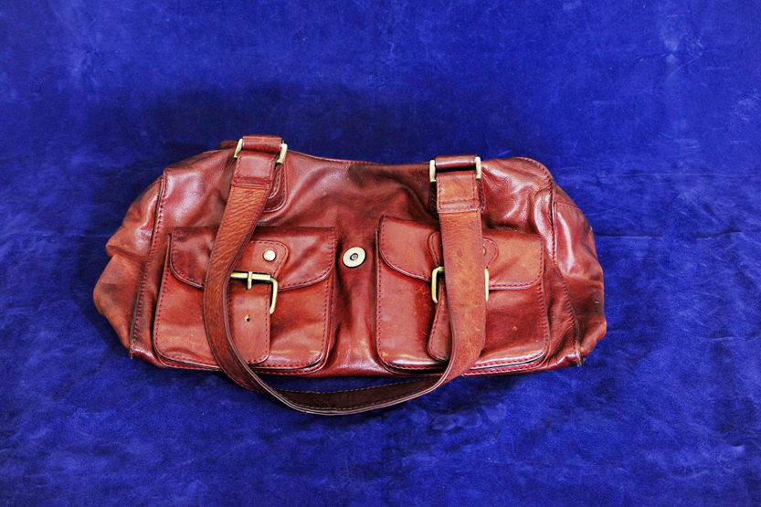 A Bodenschatz red leather handbag with interior compartments and exterior pockets.