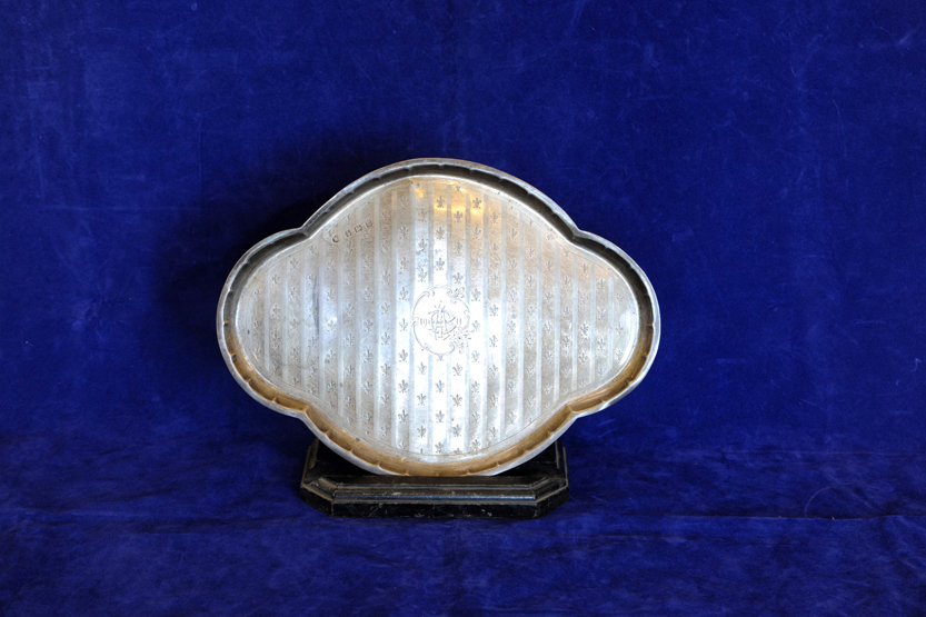A George V silver dressing table tray with fleur de lys and banded decoration, the central cartouche