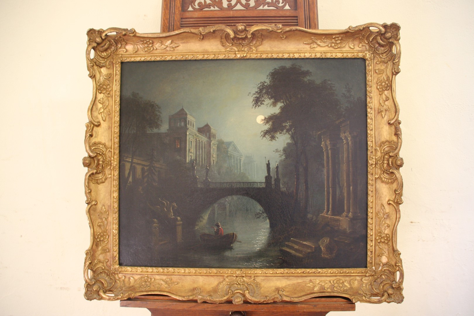 A 19th century oil on canvas of an Italian canal scene lit by moonlight. 22¾ by 19ins. In a gilt