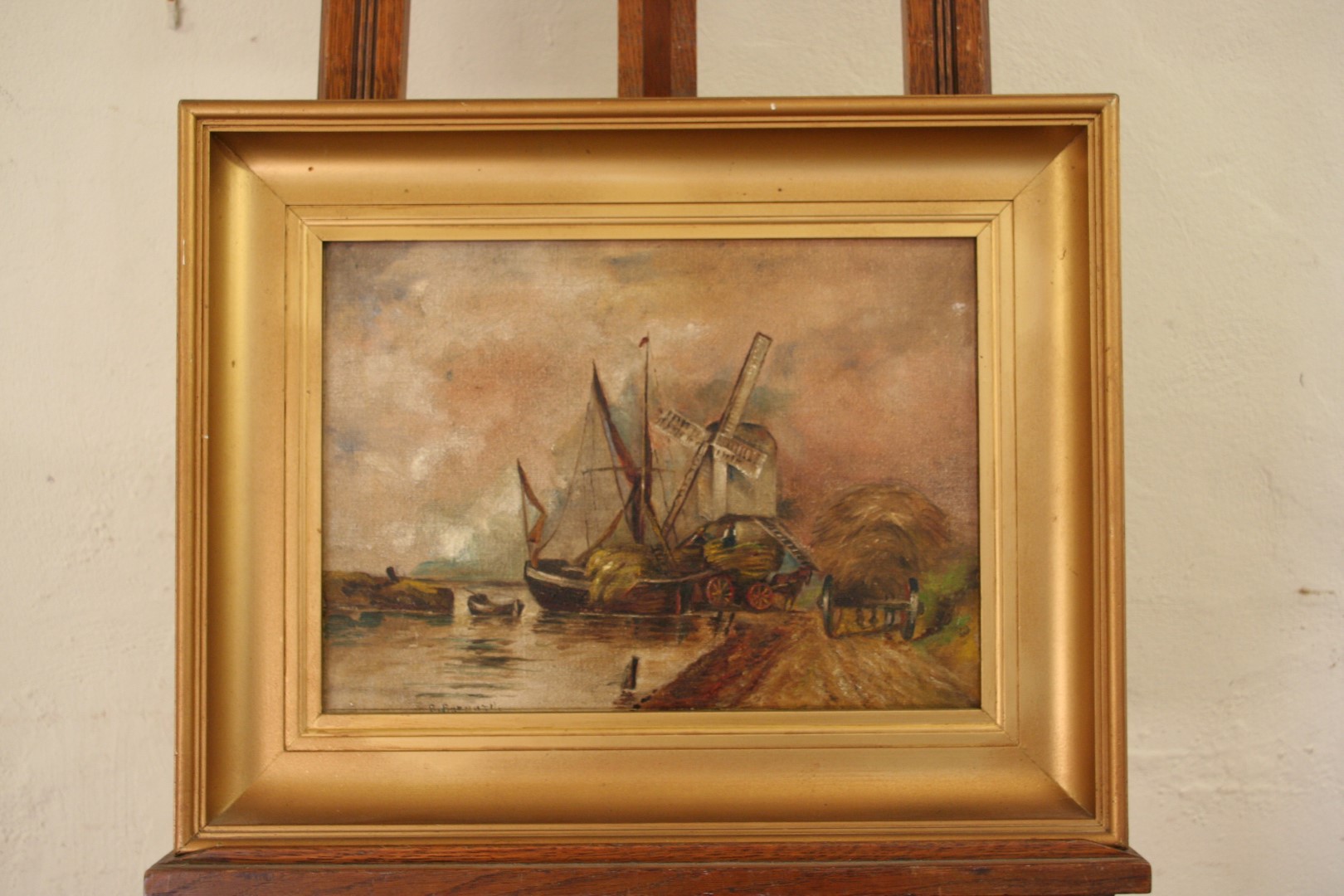 A 19th century oil on canvas, Dutch landscape scene with windmill to the rear ground and straw being