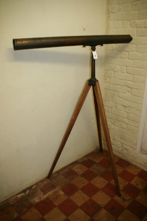 A late 19th century brass astronomical telescope with adjustable eye piece on a fold-out tripod,