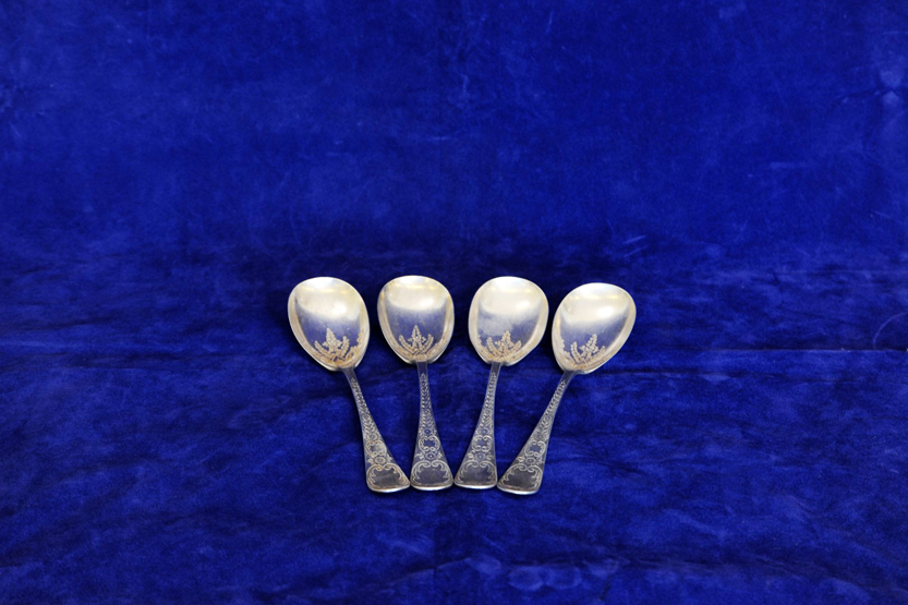 A set of four late Victorian silver serving spoons with rococo scroll stylised leaf and flower