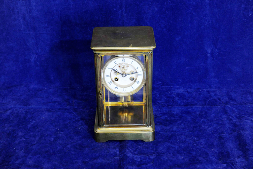 A brass four glass clock, the twin train movement with double glass mercury filled compensated