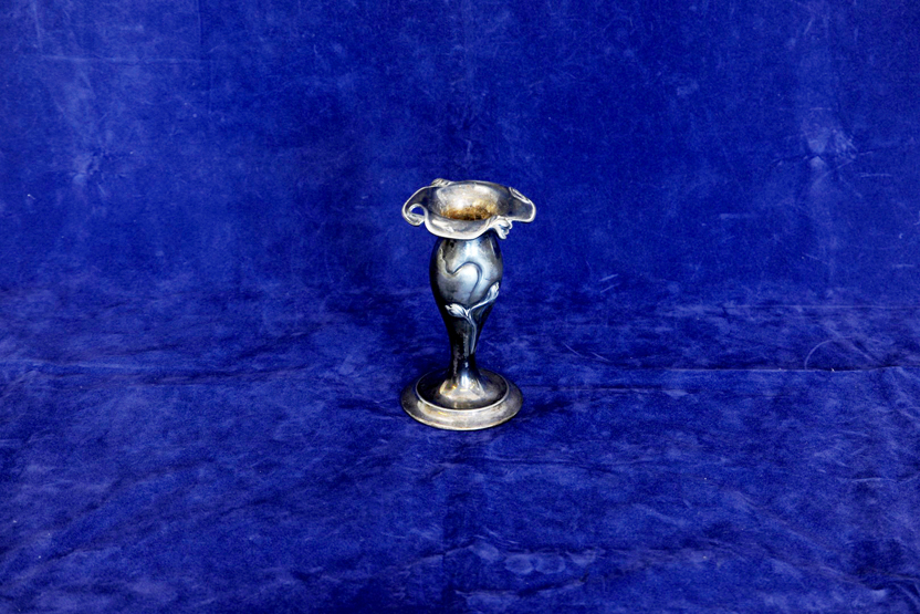 A plated Art Nouveau spill vase with stylised floral decoration, on a stepped foot. 6ins high.