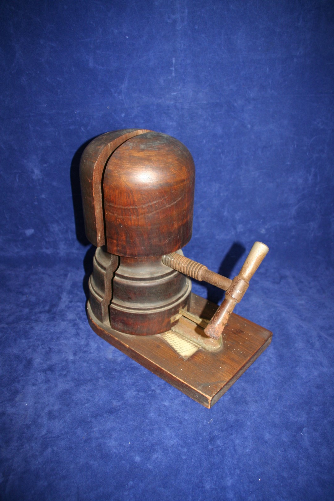 A turned mahogany hat stretcher with wrought iron screw mechanism and adjustment measurements to the