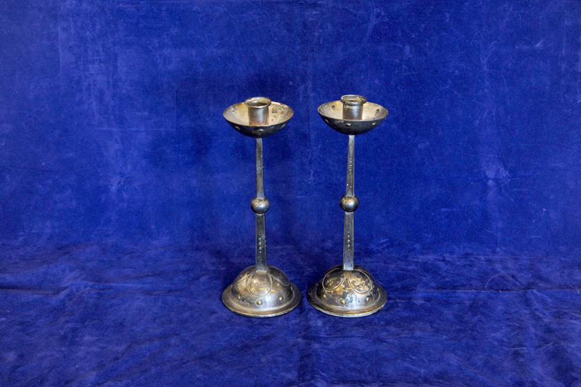 A pair of WMF Arts & Crafts candlesticks, the circular sconces with roundel decoration, the square