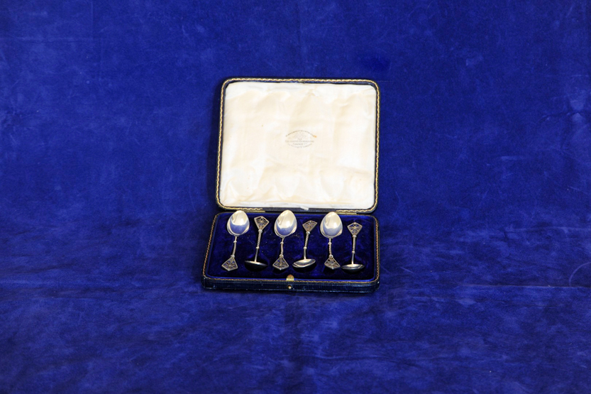 A set of six George VI silver teaspoons, the handles with stylised floral enamel decoration and