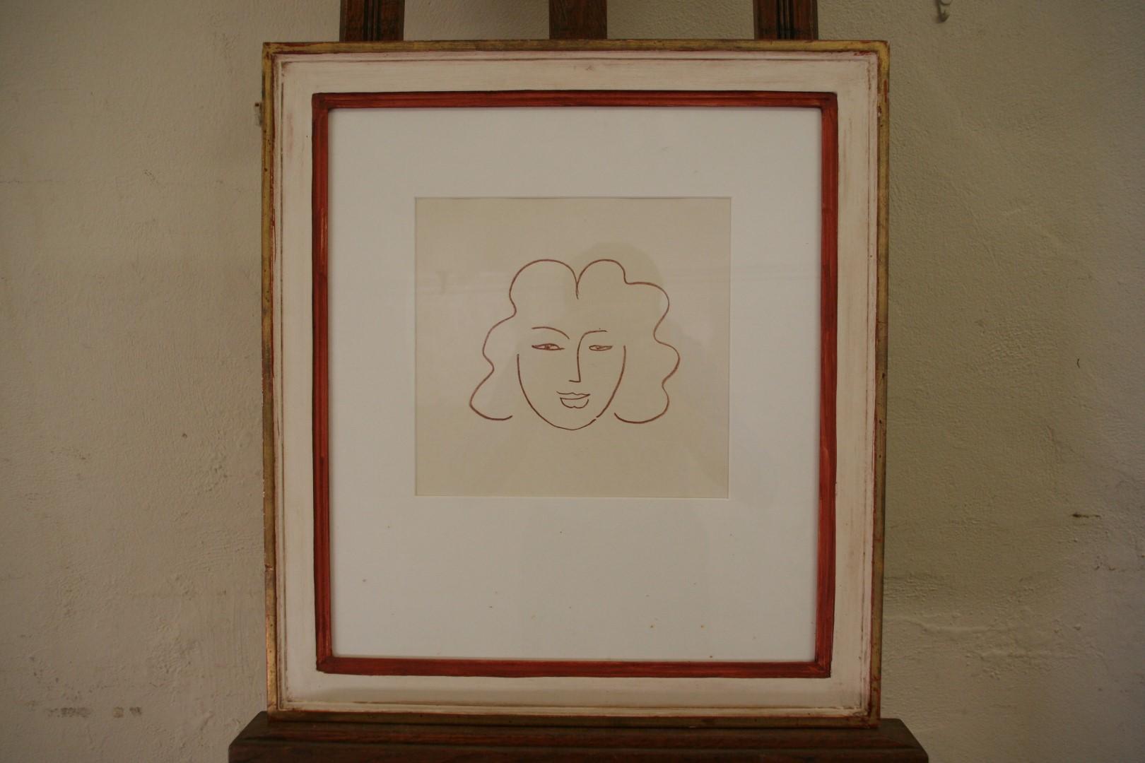 Henry Matisse, a lithograph study of a female face. 9¾ by 9¼ins. In a glazed frame.