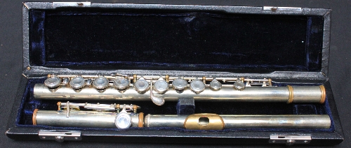 A musicians silver plated flute with case.