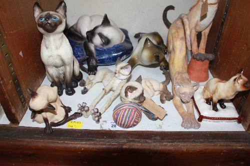 SECTION 28.  A collection of ceramic and composite Siamese cats.