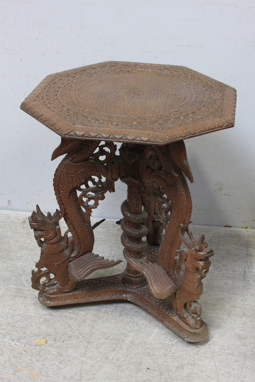 An early 20th Century Chinese carved hardwood occasional table, of octagonal form, centrally