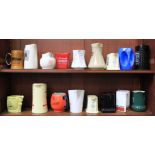 A collection of seventeen ceramic whisky jugs including some 'Wade' and 'Burleigh Ware' pieces,