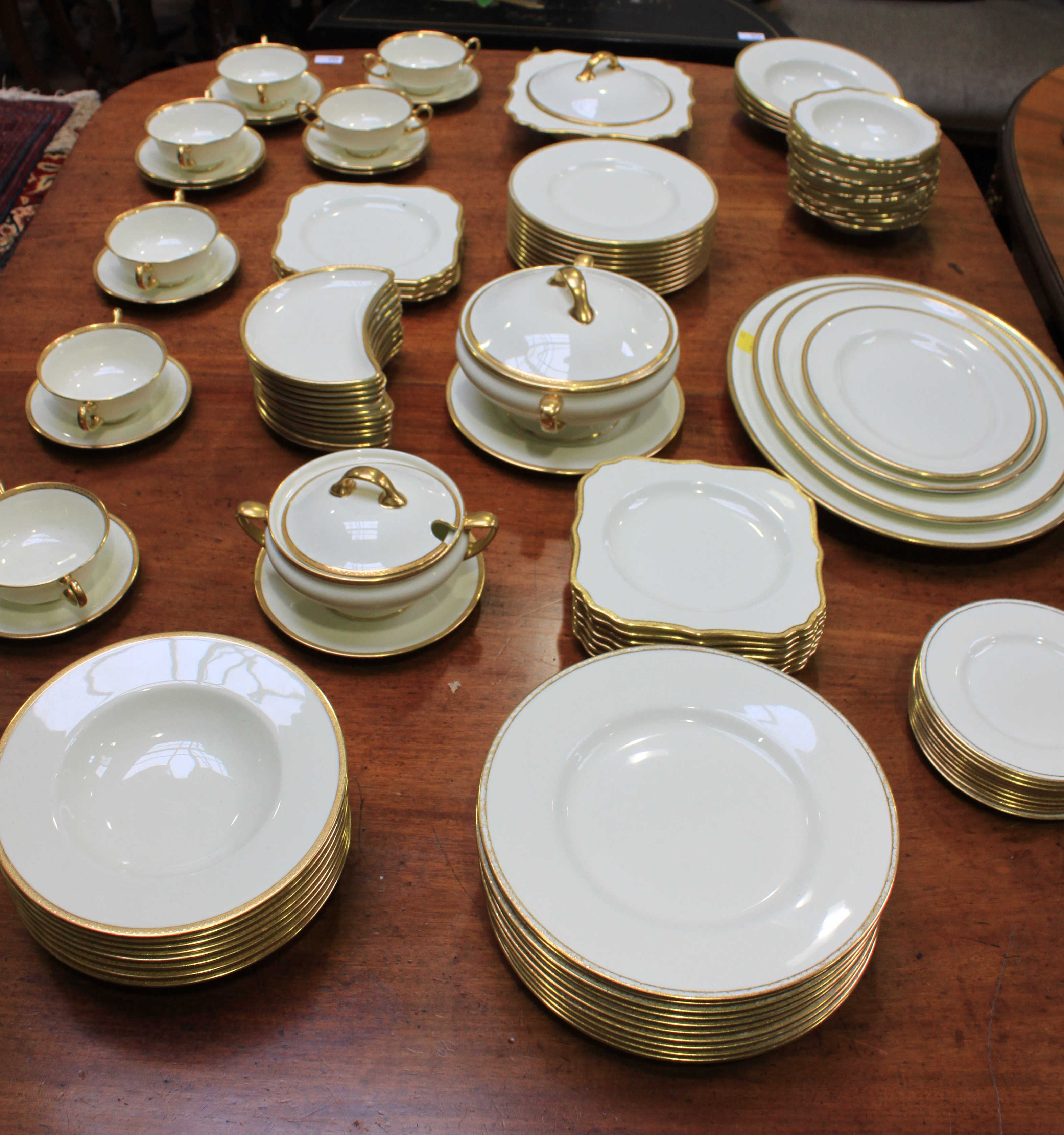 An extensive Royal Doulton dinner service with a cream and gilt pattern comprising of