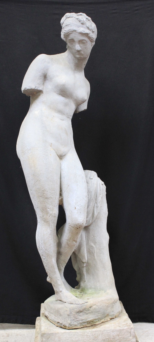 A reconstituted stone figure of the Venus De Milo on separated stepped pedestal base, 140cm high.