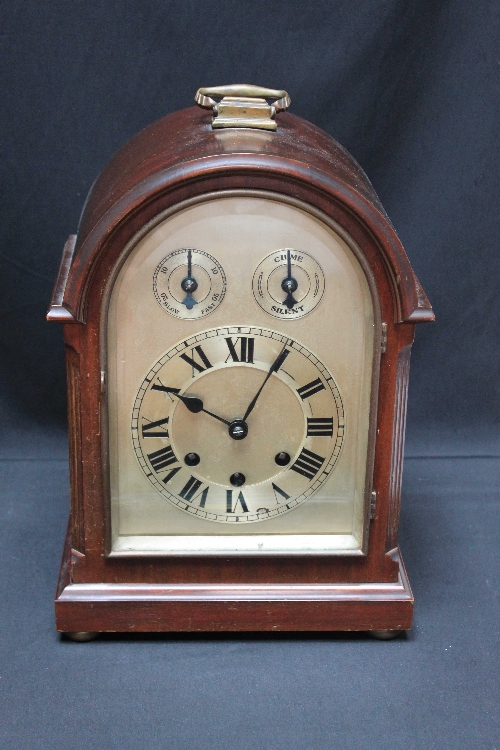 An early 20th century mahogany bracket clock with domed case, striking and chiming movement and