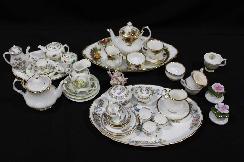 A Royal Albert ""Old Country Roses"" pattern miniature tea set and another in plain white with