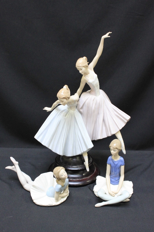A Lladro porcelain figure group of two ballerinas, on turned wooden base, together with two smaller