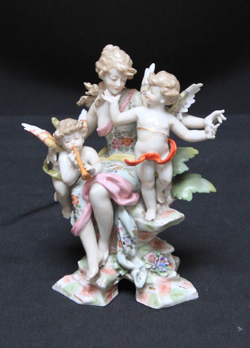 A 19th Century Meissen porcelain figure group, of a classical maiden, seated upon a rock, with