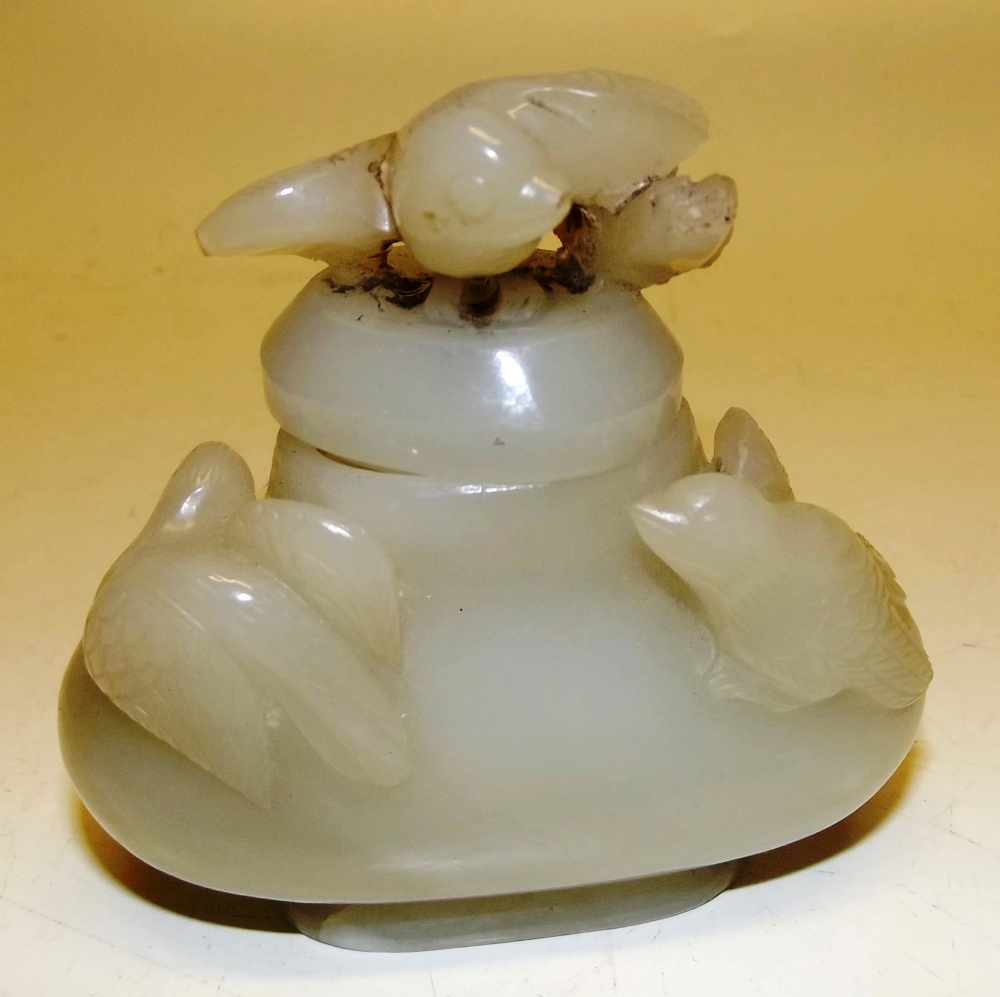 A Chinese jade pot, carved with birds, the cover also carved a bird and a chick, (cracked) 3.5in (