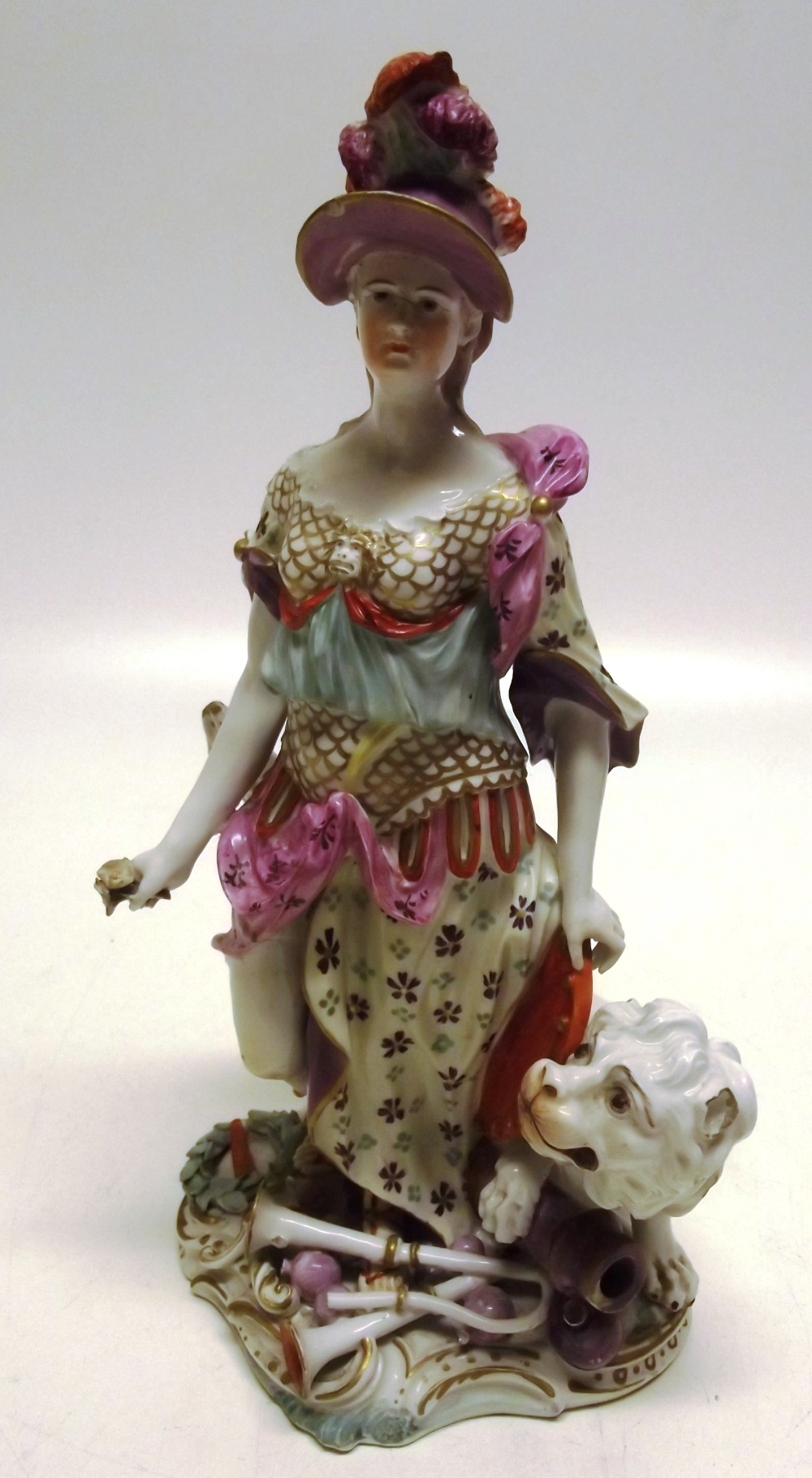 An eighteenth century Derby porcelain figure of Britannia, with a lion and a globe, the rococo base