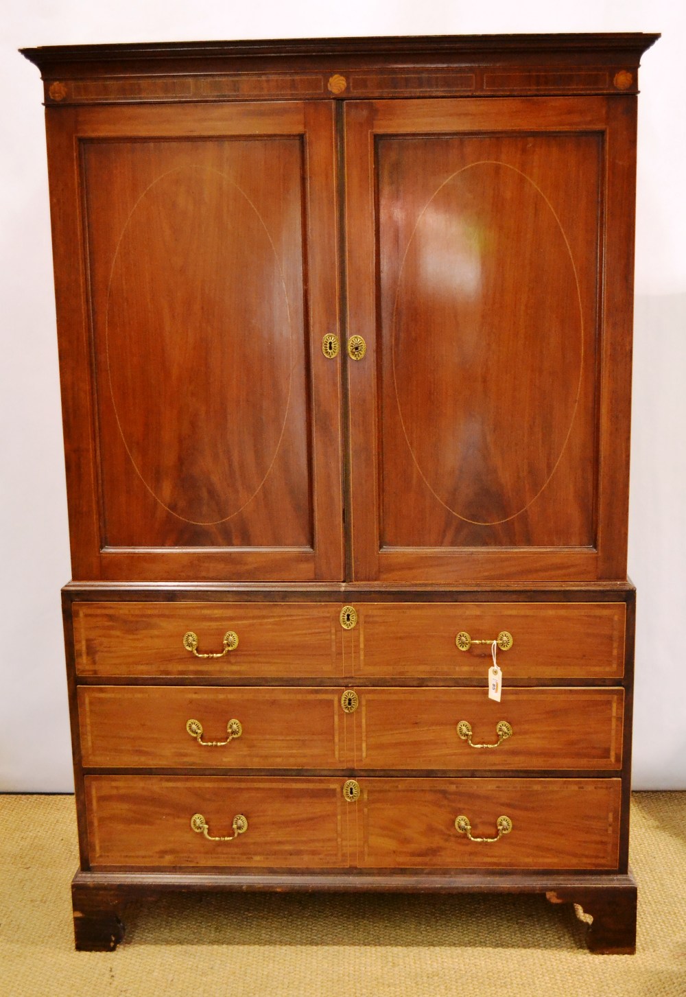 A Channel Islands early nineteenth century mahogany linen press, inlaid stringing with satinwood