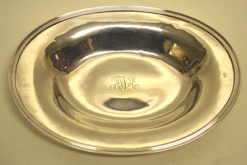 A Tiffany silver oval bread dish, engraved initials having a reeded edge. 11.5in (29cm). Early