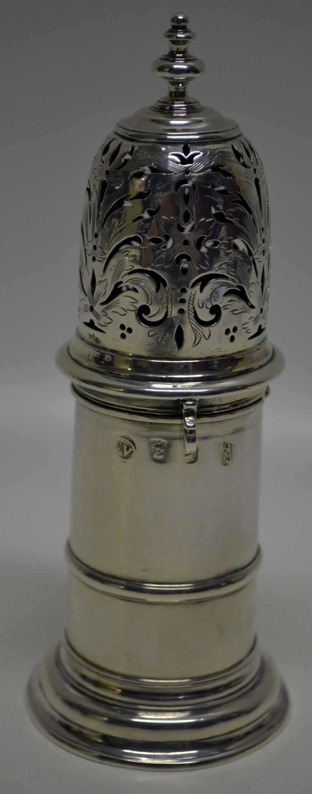 A William III silver lighthouse caster, the body with a girdle moulding, the pierced engraved
