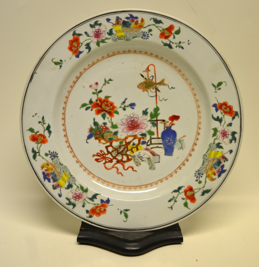 A Chinese mid eighteenth century famille rose porcelain charger, decorated foliage and a fish on a