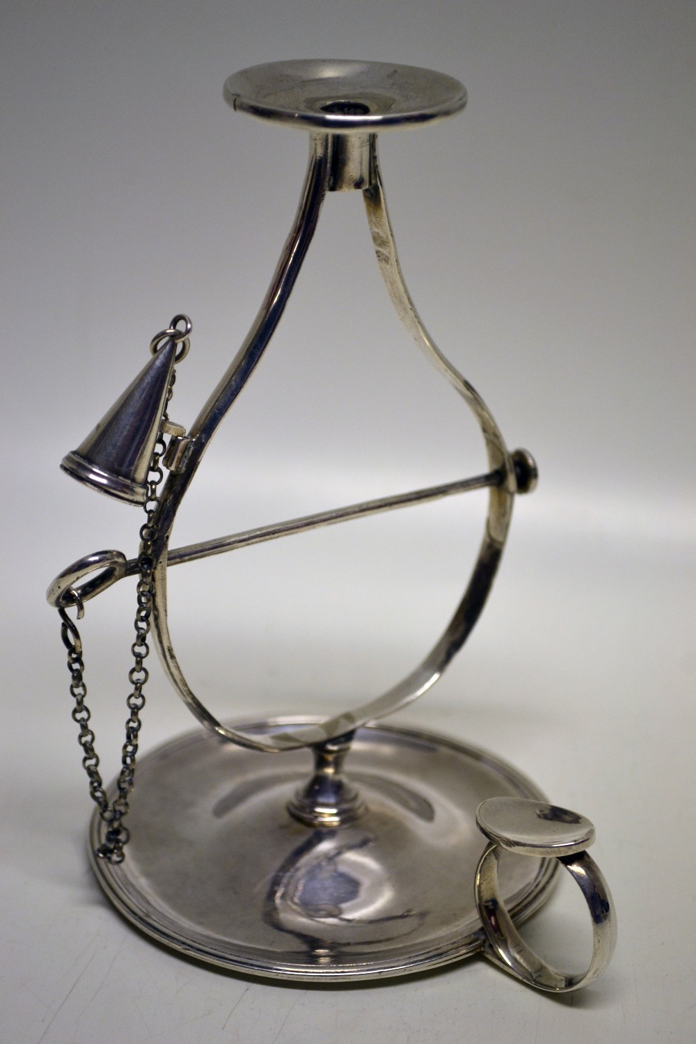 A George III Scottish silver wax jack, the open frame with an extinguisher, a thumbpiece to the ring