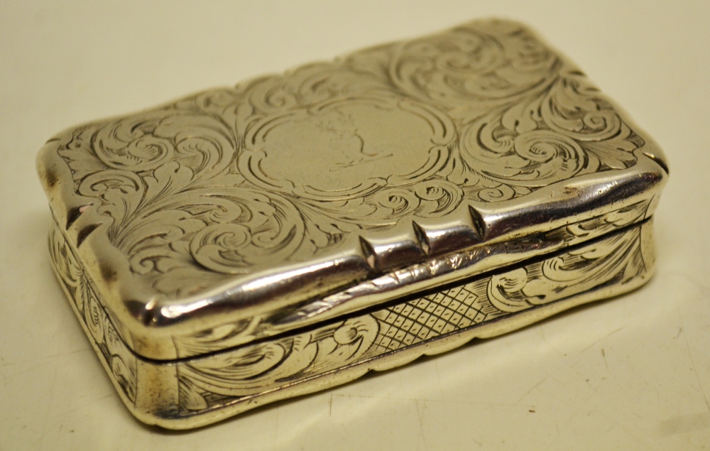 A Victorian silver foliage engraved rectangular snuff box, engraved a crest, a gilded interior 2.5in