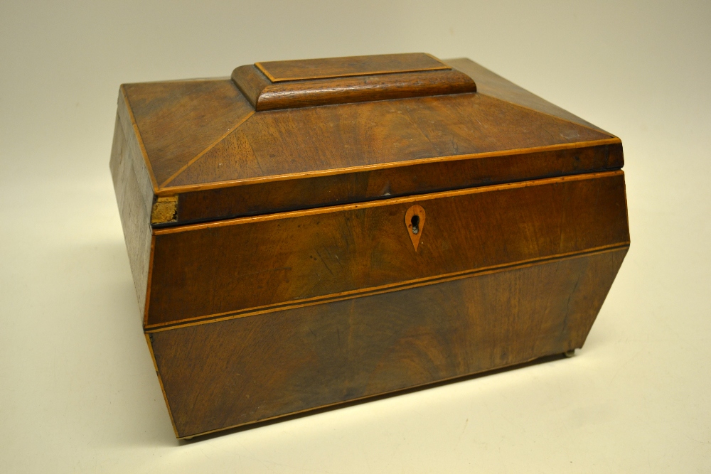 A Regency mahogany veneered sarcophagus shape work box, inlaid stringing, on small brass ball