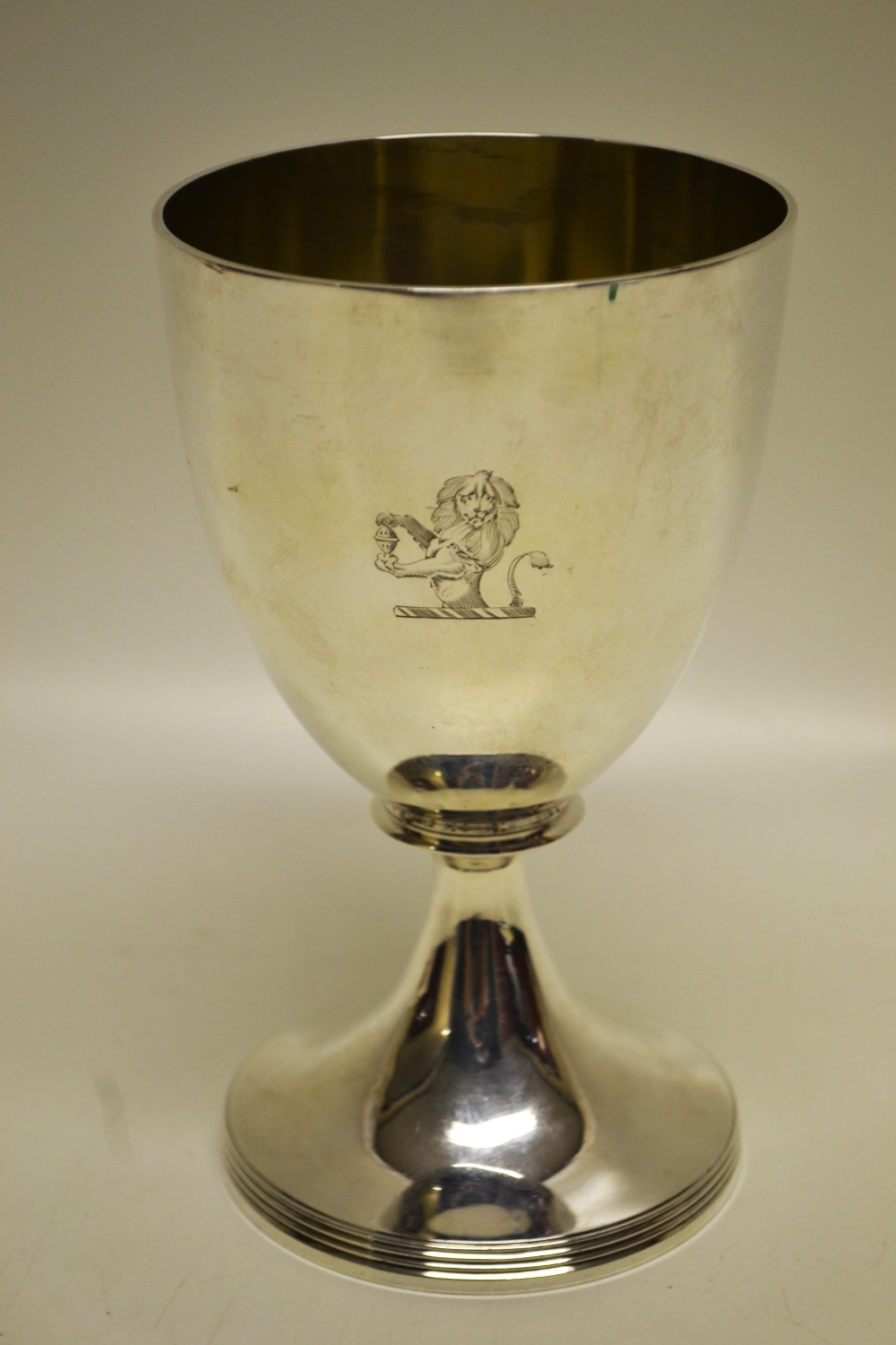 A George III silver wine goblet, engraved a crest of a lion holding up a salt, on a reeded edge