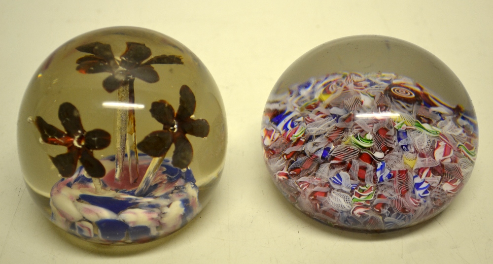 Two nineteenth century glass paper weights, one of a mixture of canes and a paper label of a